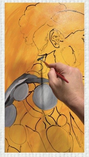 Painting in progress: the artist's hand adds forms to the figure